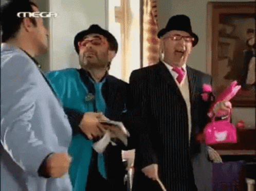 A Group Of Men Are Standing Next To Each Other In A Room With Mega Written On The Bottom Of The Screen GIF