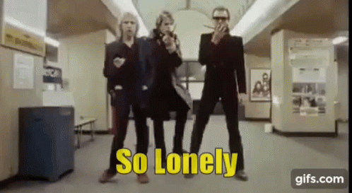 A Group Of Men Are Standing Next To Each Other In A Room With The Words `` So Lonely '' Written On The Screen . GIF