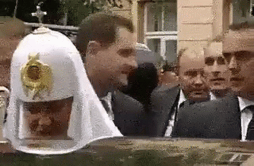 A Group Of Men Are Standing Next To Each Other In Front Of A Building . GIF