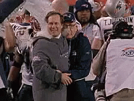 A Group Of Men Are Standing Next To Each Other On A Field . GIF