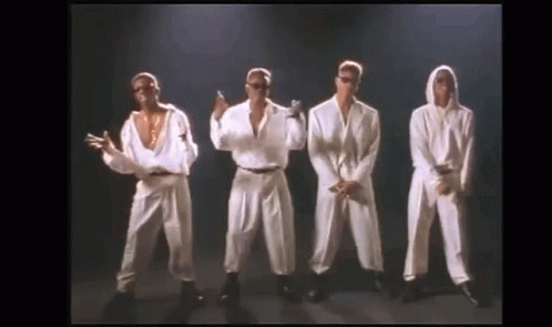 A Group Of Men Are Standing Next To Each Other On A Stage And Dancing . GIF