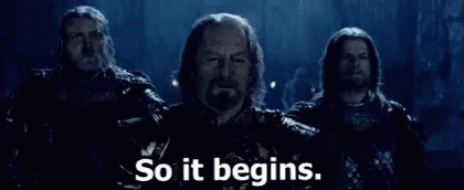 A Group Of Men Are Standing Next To Each Other With The Words `` So It Begins '' Written On The Bottom . GIF