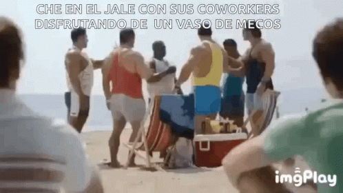 A Group Of Men Are Standing On A Beach And Talking To Each Other . GIF