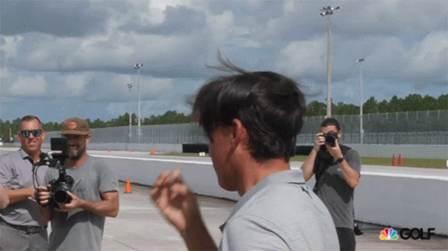 A Group Of Men Are Taking Pictures Of A Man With The Nbc Golf Logo In The Corner GIF