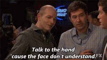 A Group Of Men Are Talking To Each Other In A Bar . GIF