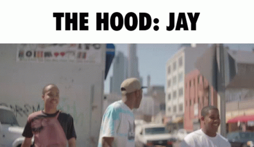 A Group Of Men Are Walking Down A Street With The Words " The Hood Jay " Above Them GIF