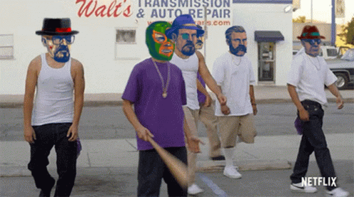 a group of men are walking down the street in front of a walt 's transmission and auto repair store