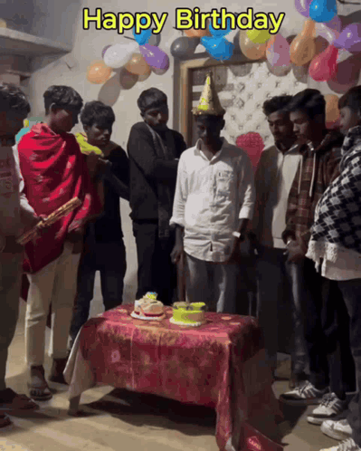 A Group Of Men Celebrate A Birthday With Balloons And A Cake GIF