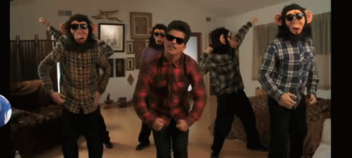 A Group Of Men Dressed As Monkeys Are Dancing In A Living Room GIF