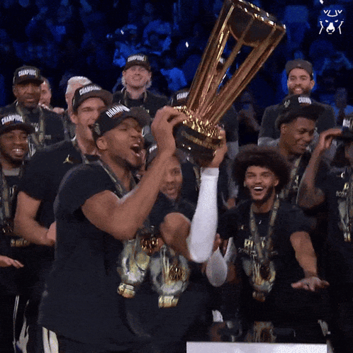 A Group Of Men Holding A Trophy With The Word Champions On It GIF