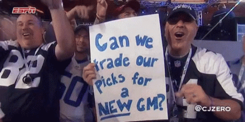 A Group Of Men Holding Up A Sign That Says " Can We Trade Our Picks For A New Gm " GIF