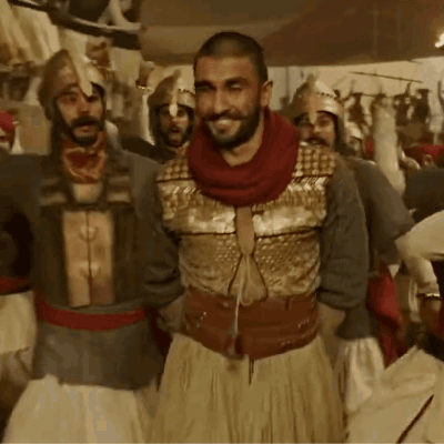 A Group Of Men In Armor Are Standing Together GIF