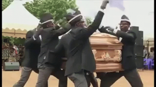 A Group Of Men In Black Suits Are Carrying A Coffin . GIF