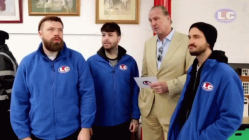 A Group Of Men In Blue Jackets With Lc On Them GIF
