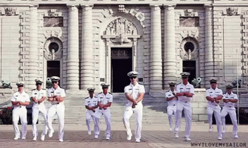 A Group Of Men In Military Uniforms Are Dancing In Front Of A Building That Says Why I Love My Sailor GIF