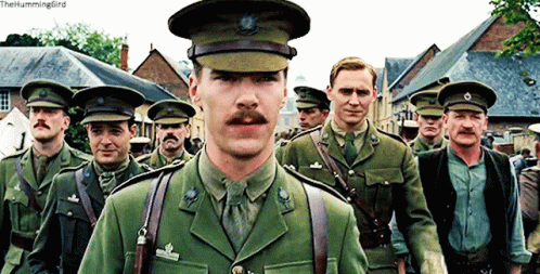 a group of men in military uniforms are walking down a street and the caption reads the hummingbird