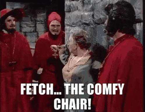 A Group Of Men In Red Robes Are Standing Next To A Woman In A Blue Dress And Talking To Her . GIF