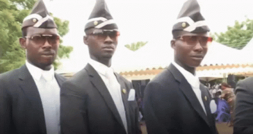 A Group Of Men In Suits And Hats Are Standing In A Line . GIF