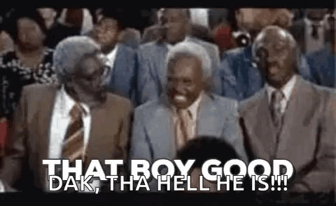 A Group Of Men In Suits And Ties Are Sitting In A Crowd . GIF