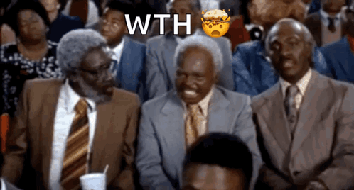 a group of men in suits and ties are sitting in a crowd with the word wth written above them