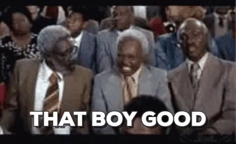 A Group Of Men In Suits And Ties Are Sitting In A Stadium . GIF