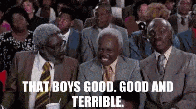 A Group Of Men In Suits And Ties Are Sitting In A Theatre . GIF