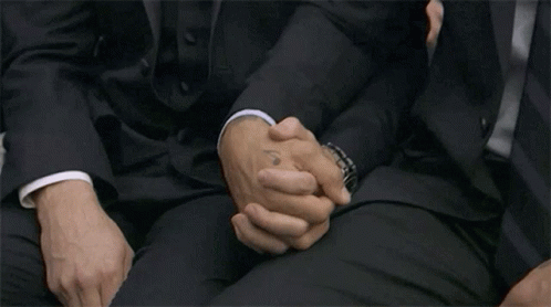 Men In Suits Sitting And Holding Hands GIF