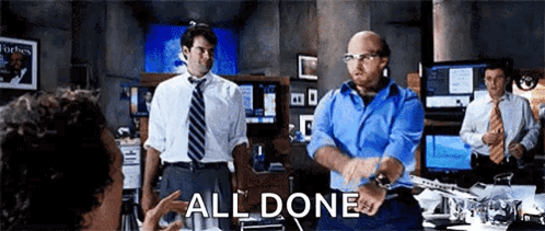 A Group Of Men In Suits And Ties Are Standing In A Room With The Words All Done Written On The Screen . GIF