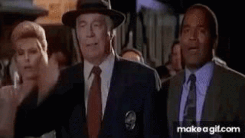 A Group Of Men In Suits And Ties Are Standing Next To Each Other In A Room . GIF
