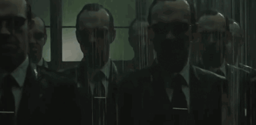 a group of men in suits and ties are standing next to each other in a room .