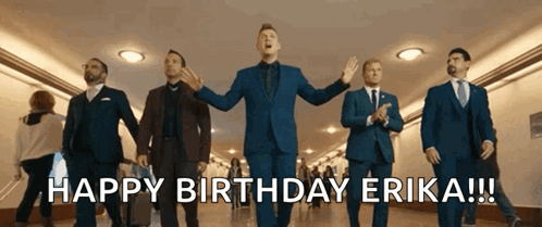 A Group Of Men In Suits And Ties Are Walking Down A Hallway And Singing Happy Birthday Erika GIF