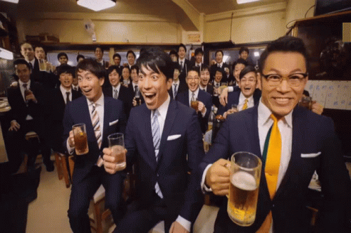 A Group Of Men In Suits And Ties Toasting With Beer Mugs GIF