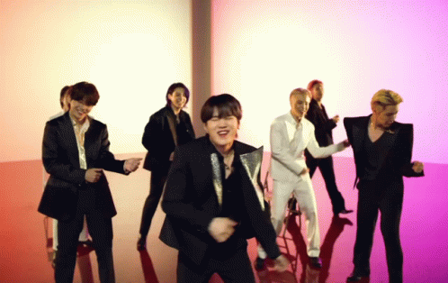 A Group Of Men In Suits Are Dancing Together On A Red Floor GIF