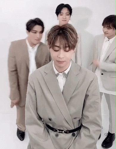 A Group Of Men In Suits Are Posing For A Picture . GIF