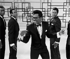 A Group Of Men In Tuxedos And Bow Ties Are Dancing GIF