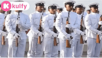 A Group Of Men In White Uniforms Are Standing In A Line With Their Guns .. GIF