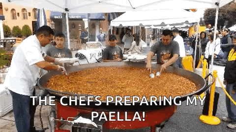 A Group Of Men Preparing Paella In A Large Pan With The Caption The Chefs Preparing My Paella GIF