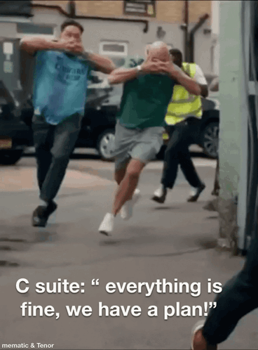 A Group Of Men Running Down A Street With The Words " C Suite Everything Is Fine We Have A Plan " GIF