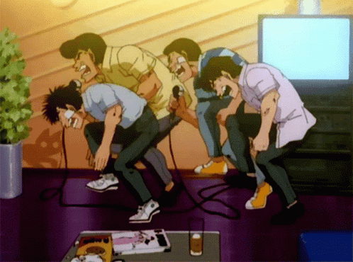 A Group Of Men Singing Into Microphones In A Room GIF