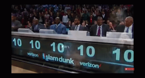 A Group Of Men Sit Behind A Scoreboard That Says Slam Dunk On It GIF