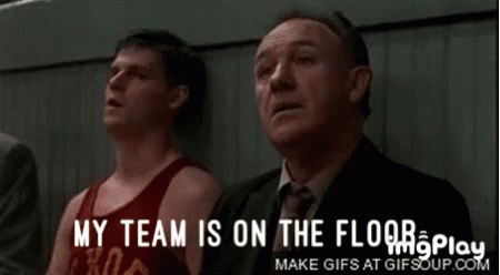 A Group Of Men Sitting In A Stadium With The Words My Team Is On The Floor GIF