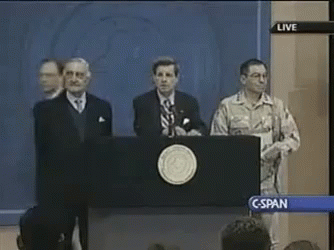 A Group Of Men Standing Behind A Podium With A Live Sign Above Them GIF