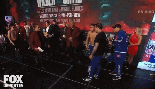 A Group Of Men Standing In Front Of A Fox Deportes Sign GIF