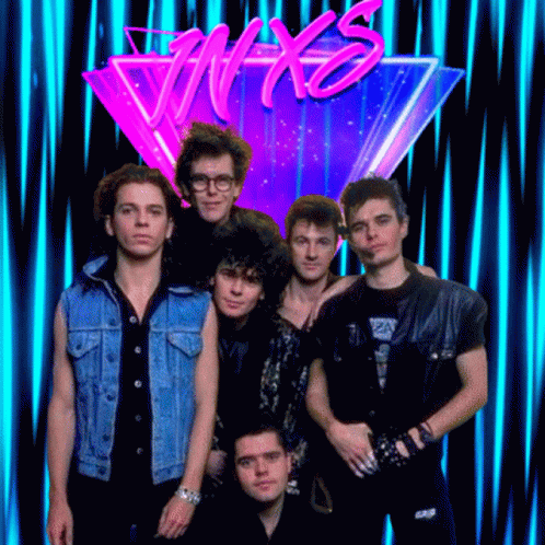 A Group Of Men Standing In Front Of A Neon Sign That Says Nyx GIF