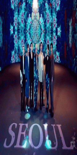 A Group Of Men Standing In Front Of A Sign That Says Seoul On It GIF