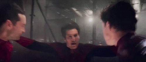 A Group Of Men Standing Next To Each Other In A Dark Room . GIF