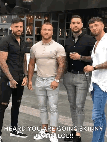 A Group Of Men Standing Next To Each Other On A Sidewalk With The Caption Heard You Are Going Skinny Jeans Lol . GIF