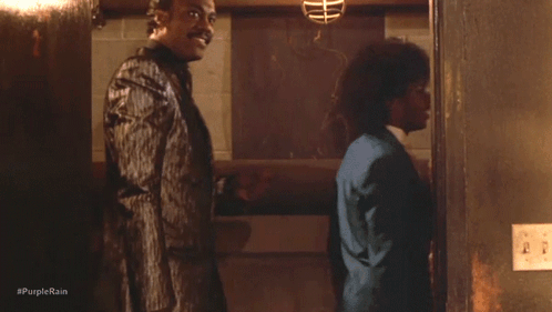 A Group Of Men Standing Next To Each Other With #Purplerain Written On The Bottom Right GIF