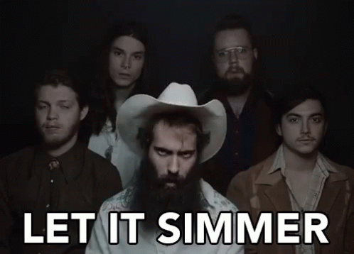 A Group Of Men Standing Next To Each Other With The Words Let It Simmer Written Above Them GIF