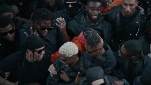 A Group Of Men Wearing Black Jackets And Sunglasses Are Standing Together GIF